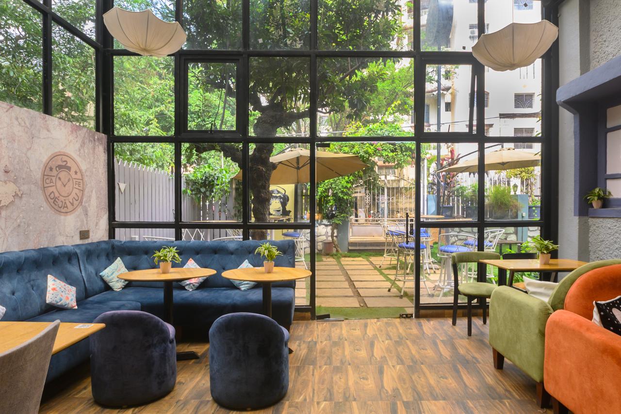 Cafe interior with large glass windows and view of the outdoor seating